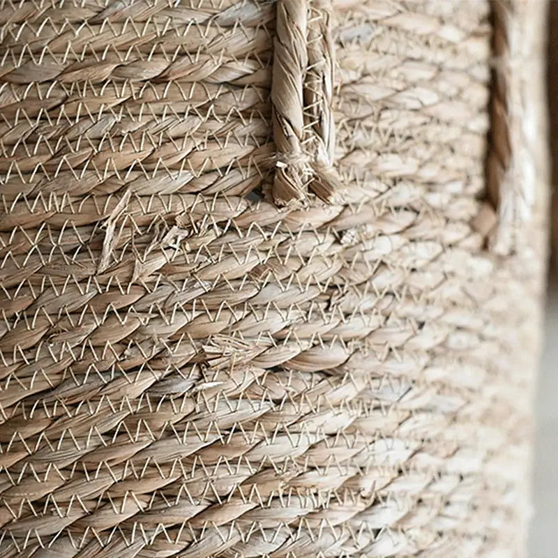 Close-up of Nordic handmade straw woven flower pot showing detailed plant fiber texture.
