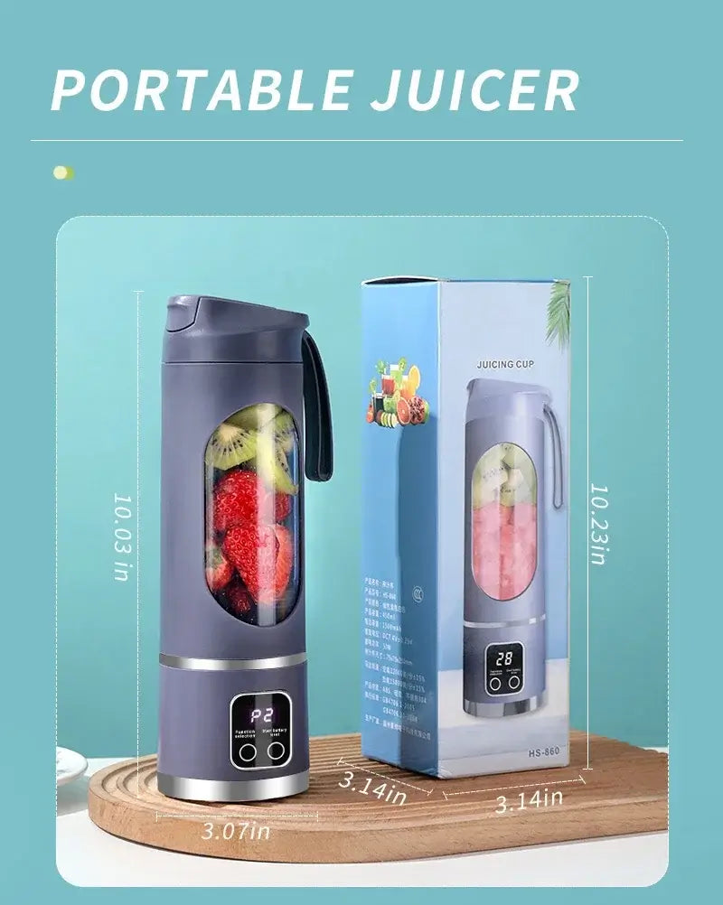 Mini portable electric juicer blender with fruits inside, next to packaging box.